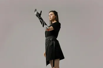 A woman with a bionic arm, representing the seamless integration of technology and the human body.