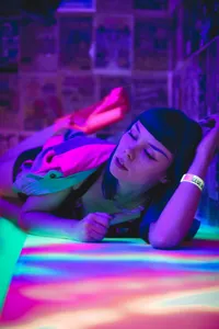 A woman in a futuristic setting with glowing lights, representing an AI companion.