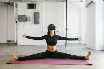 A woman wearing a VR headset while doing yoga, illustrating the integration of digital experiences into daily life.